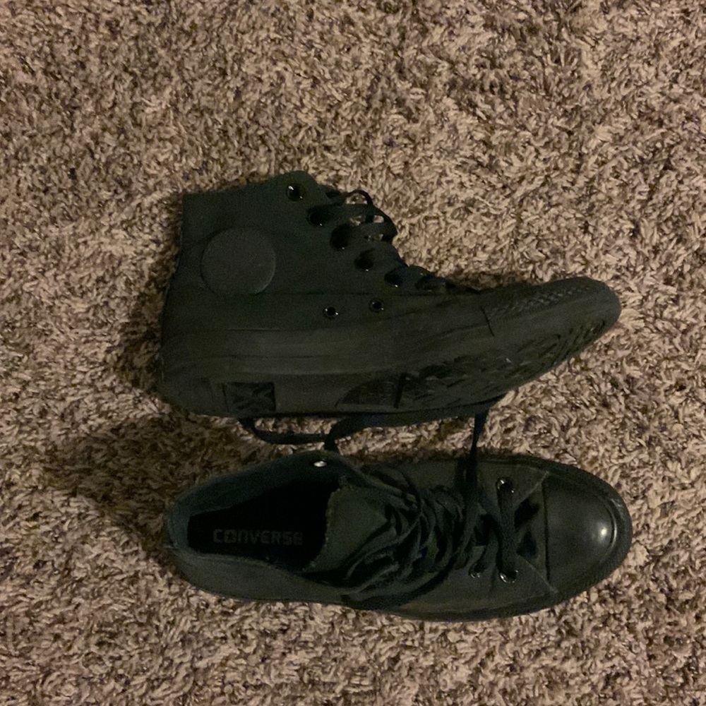 Black Converse high top sneakers.